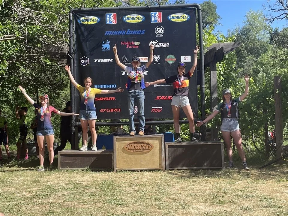 5 students standing on awards podium