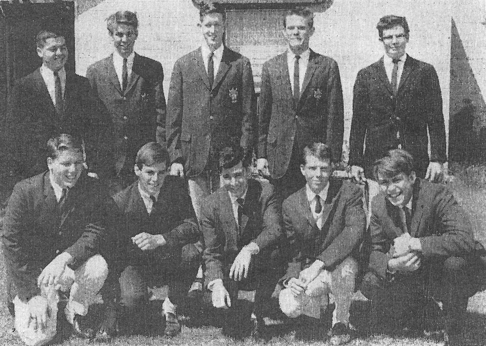 black and white photo of first graduating class of 11 boys