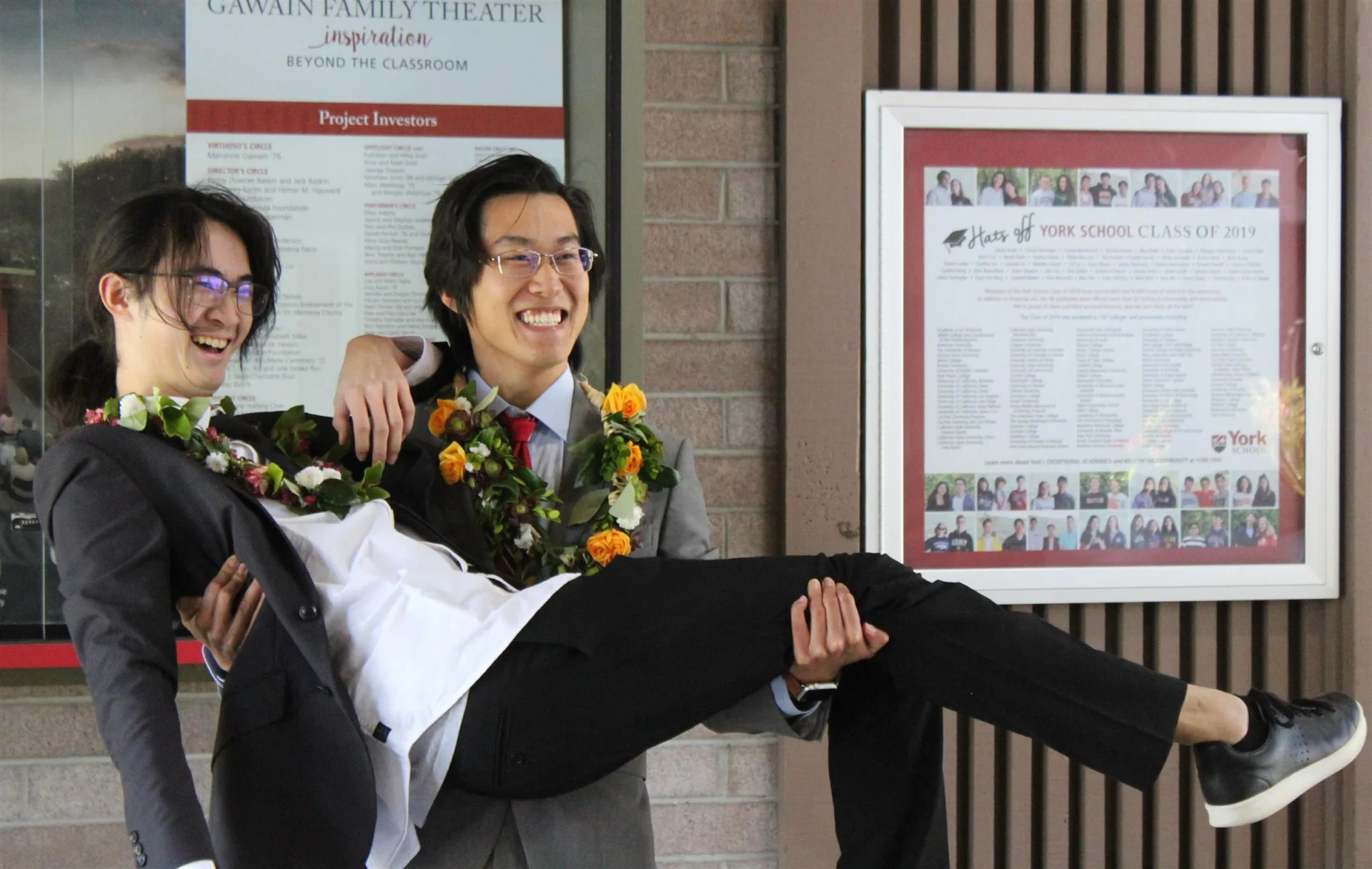 2 international students posing with flower necklaces